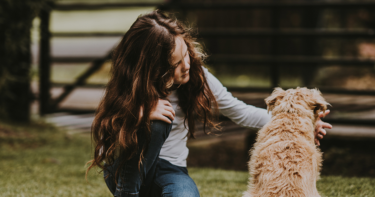 girl giving medicine to pet