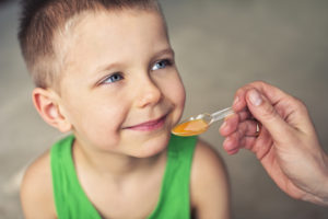 Little boy taking medicine